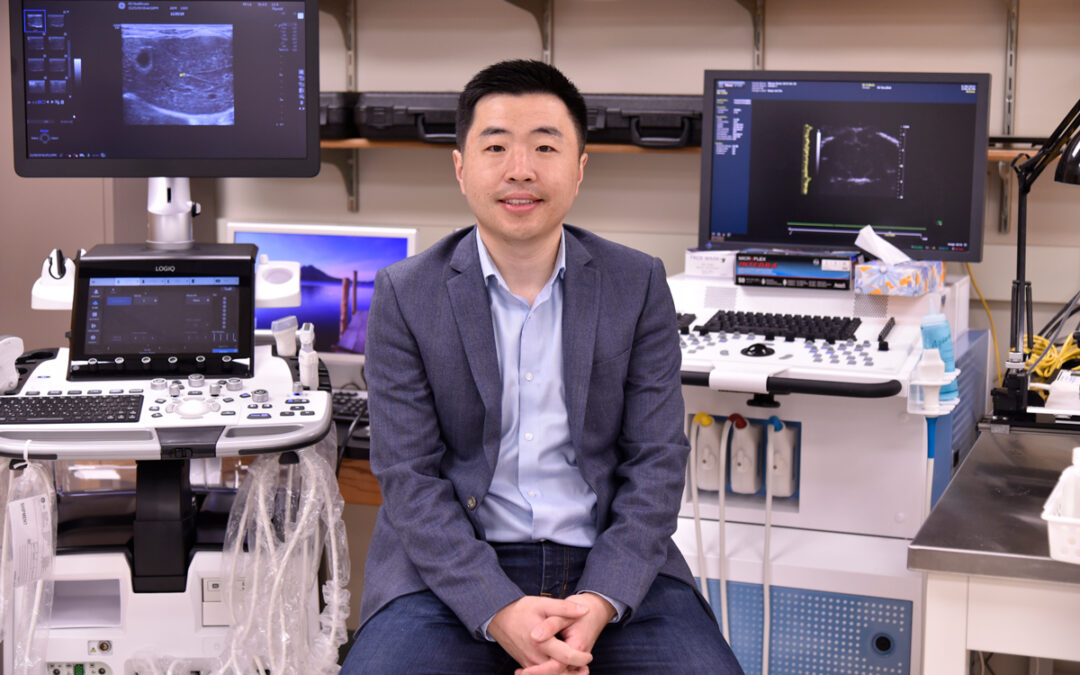 Photo of Pengfei Song with ultrasound machines